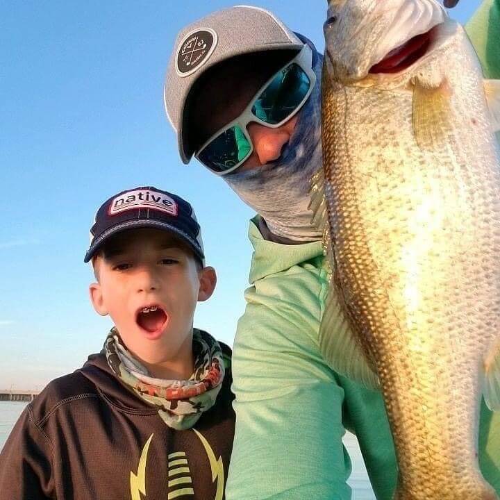 Father and son celebrating their big catch during one of our fishing trips.