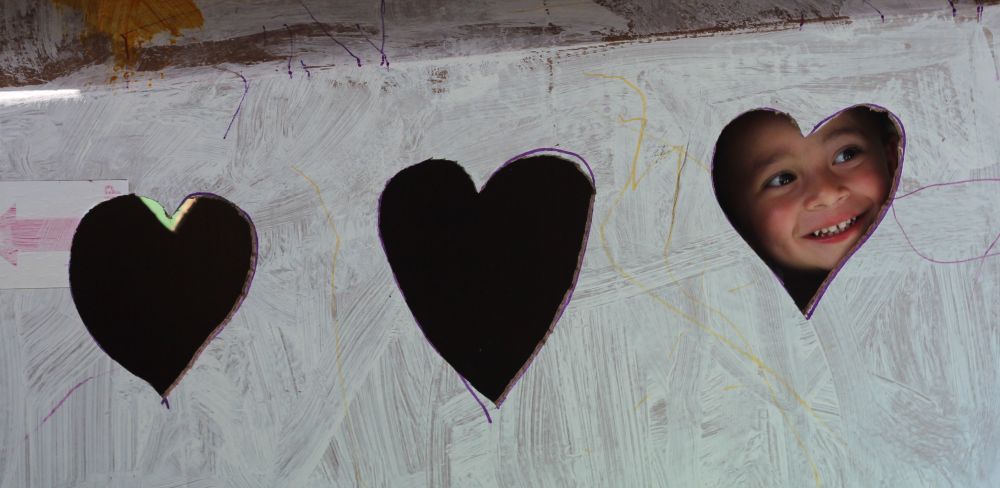 child in heart shaped cut out all our kin